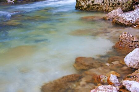 mountain river flowing between the rocksの写真素材