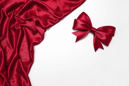 Shiny red satin ribbon on white backgroundの写真素材