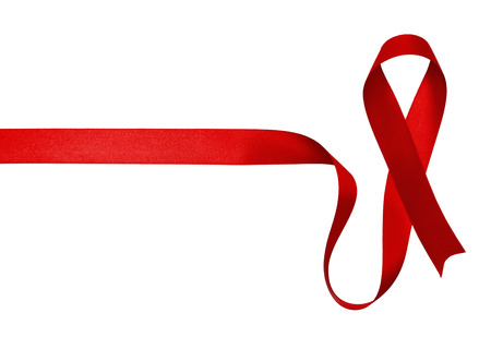 Shiny red satin ribbon on white backgroundの写真素材