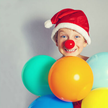boy in Santa Claus hat holding balloonsの写真素材