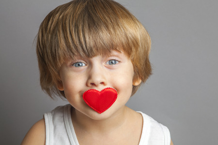 Portrait of a boy with hearts on faceの写真素材