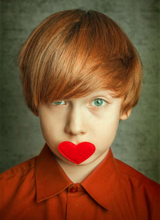 Portrait of a boy with hearts on faceの写真素材