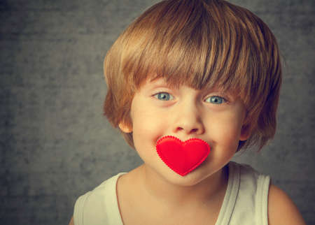 Portrait of a boy with hearts on faceの写真素材