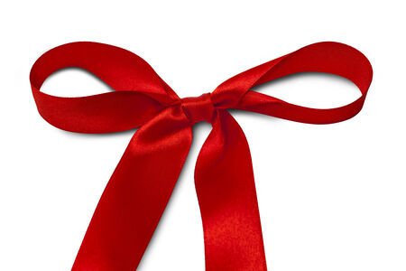 Shiny red satin ribbon on white backgroundの写真素材