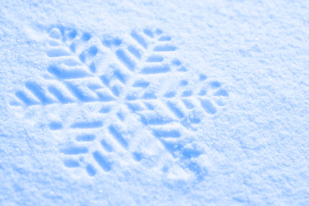 snowflake ornament against a background of snow