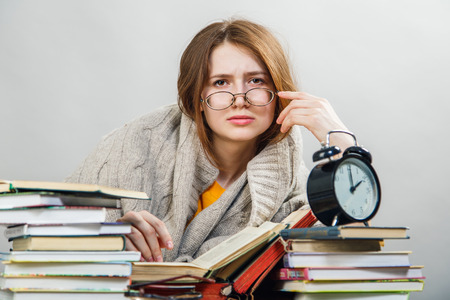 funny crazy  girl student with glasses reading booksの写真素材