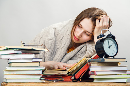 funny crazy  girl student with glasses reading booksの写真素材