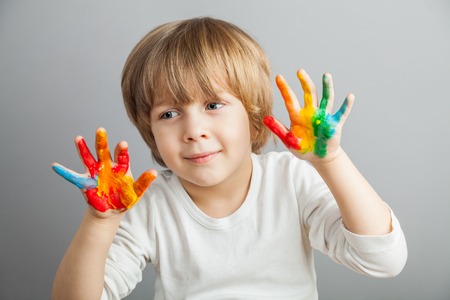 little girl and boy hands painted  in colorful paintsの写真素材