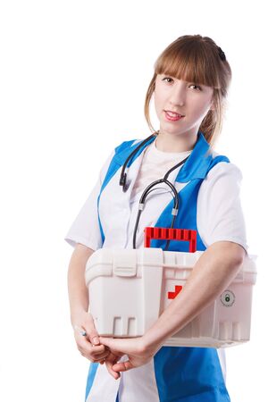 Portrait of young woman doctor with white coat standing  in hospitalの写真素材