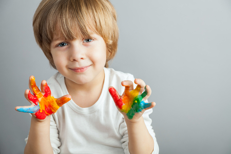 little girl and boy hands painted  in colorful paintsの写真素材