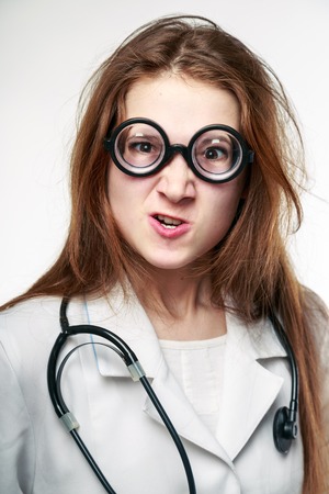 Funny doctor holding a pillの写真素材