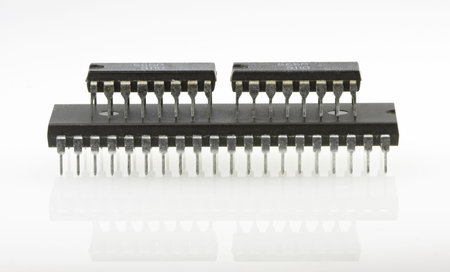 Two small chips standing on big multipin computer chip