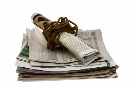Newspaper wrapped by rusty chainの写真素材