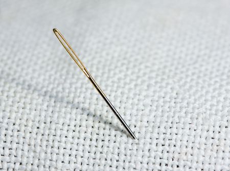 Macro of sewing needle on white fabricの写真素材