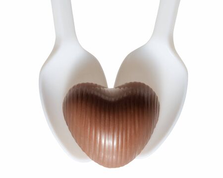 Two plastic teaspoons and chocolate candyの写真素材