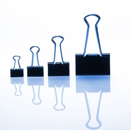 binders on white reflective plane, blue tintの写真素材