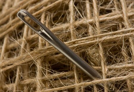 Macro of sewing needle on thread clew backgroundの写真素材