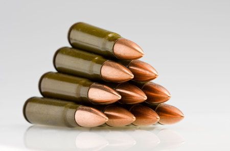 Bullets arranged in pile over white background