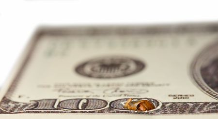 Macro shot of caterpillar perforating money - financial crisis conceptの写真素材