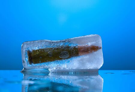 Melting ice cube with gun machine cartridgeの写真素材