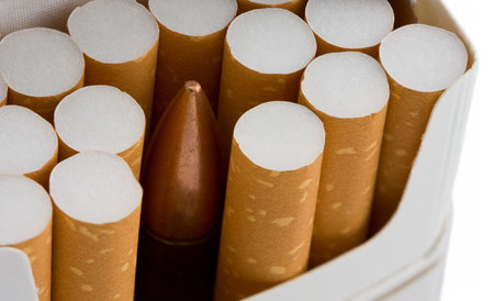 cartridge in cigarette box as hidden danger of smoking conceptの写真素材