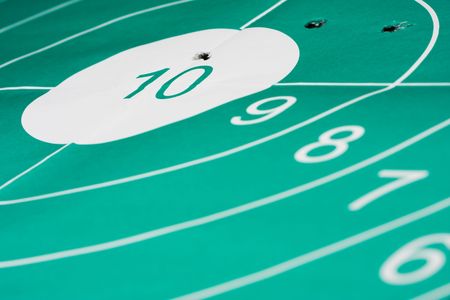 Close-up of target bullseye with bullet holesの写真素材