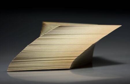 Shifted and tilted paper stack over blackの写真素材