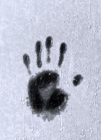 Winter window glass with palm imprint on hoarfrostの写真素材