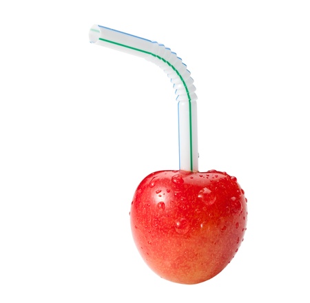 Straw and cherry isolated on white - fresh juice drink conceptの写真素材