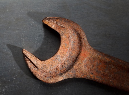 Grungy spanner on stainless steel dark backgroundの写真素材