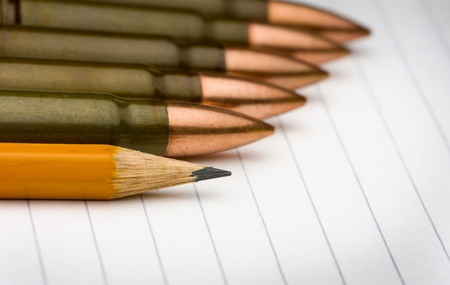 Row of cartridges and pencil on notepad - power of written word conceptの写真素材