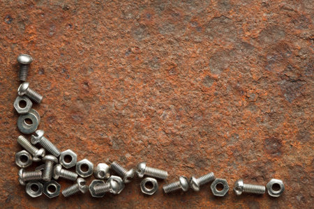 Bolts and nuts on rusted iron plate with copy space for text
