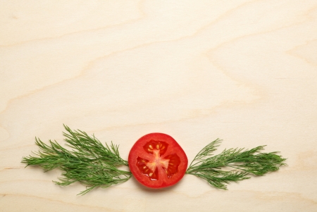 Macro of tomato and dill bunch on wood backgroundの写真素材