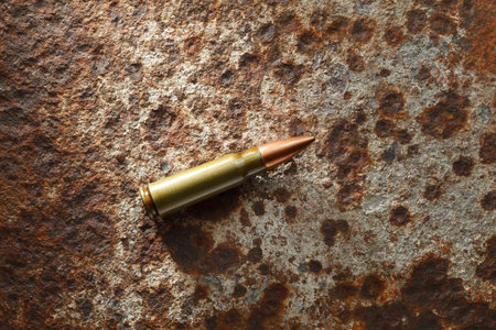 Studio shoot of kalashnikov bullet on rusted iron plate
