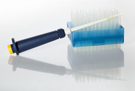 Closeup of laboratory pipet and disposable tips rackの写真素材