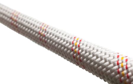 Close-up of stretched thick cable isolated on whiteの写真素材