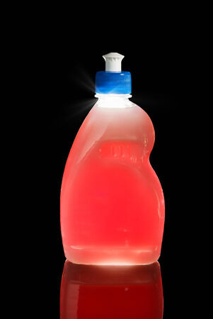 Bottle of dishwashing red liquid isolated on black, backlit technique
の写真素材