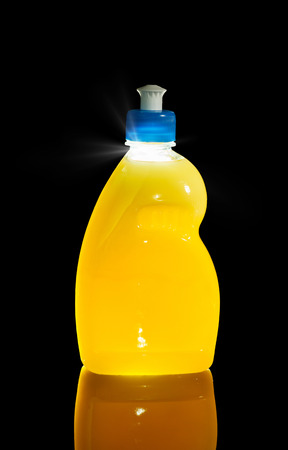 Bottle of dishwashing yellow liquid isolated on black, backlit technique
の写真素材