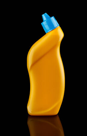 Yellow plastic bottle with blue cap isolated on black
の写真素材