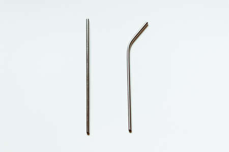 Two metal reusable straws for drinks on a white background.の写真素材