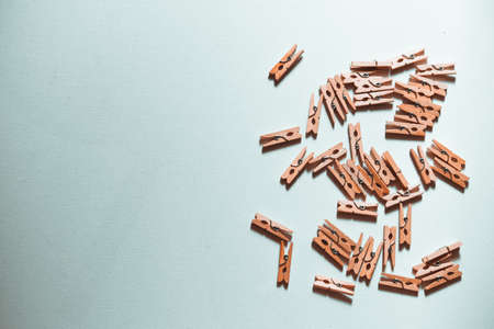 Background for text with a lot of small wooden clothespins on the right.の写真素材
