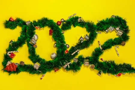 New Year, 2022. The number 2022 is laid out from a New Years garland and New Years toys. New Year celebration. High quality photoの写真素材