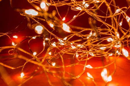 Christmas LED garland in hands. Creation of coziness at home for the New Year. High quality photoの写真素材