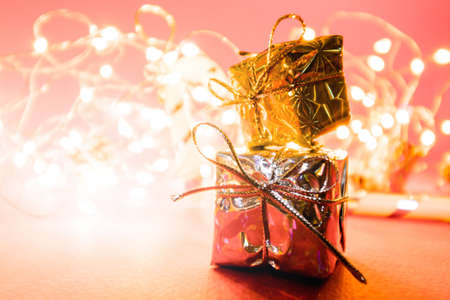 Bright Christmas background with lights and lanterns with little gifts in the foreground. High quality photoの写真素材