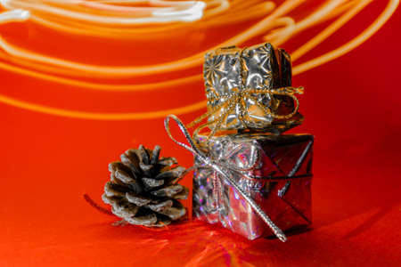 Two small gifts on a red background. Gifts in honor of the new year. High quality photoの写真素材
