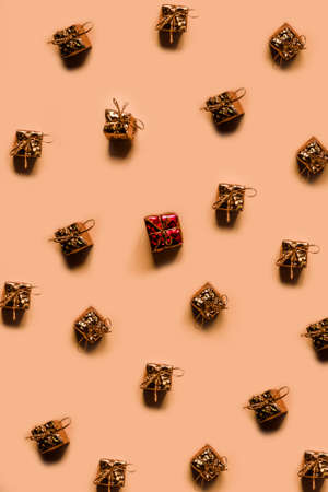 Many small identical gifts on a pale pink background. Present pattern. Isolation. High quality photoの写真素材