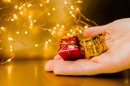 New Years gift in hand. Presenting a New Years gift. Small souvenirs. High quality photoの写真素材