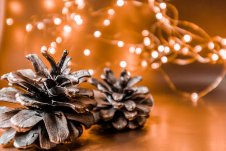 Christmas cones on a golden background with lights. Christmas background. High quality photoの写真素材