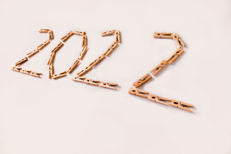 Number 2022 is made of small wooden clothespins on a white background. High quality photoの写真素材