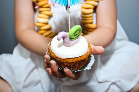 cupcake in the hands of a childの写真素材